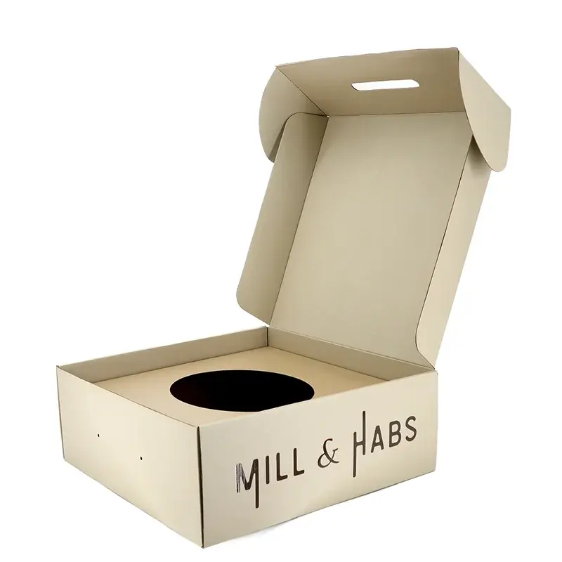 Open kraft box with a circular cutout in its insert.