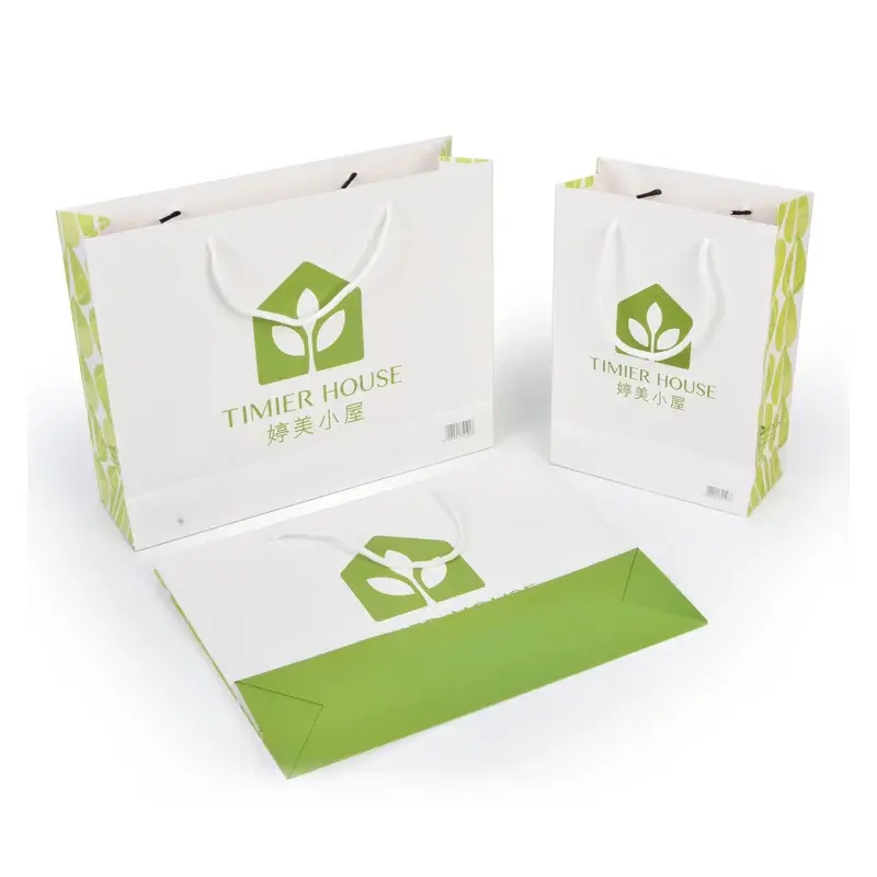 White paper bags with green printed panels and graphics.