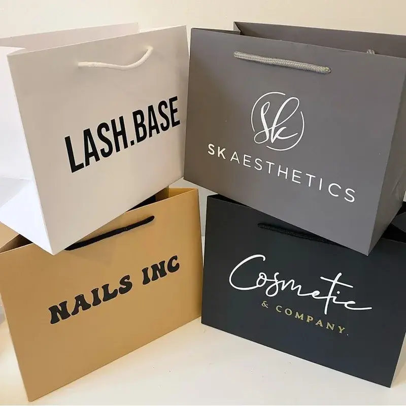 Shopping bags in neutral colors with varied printed lettering.