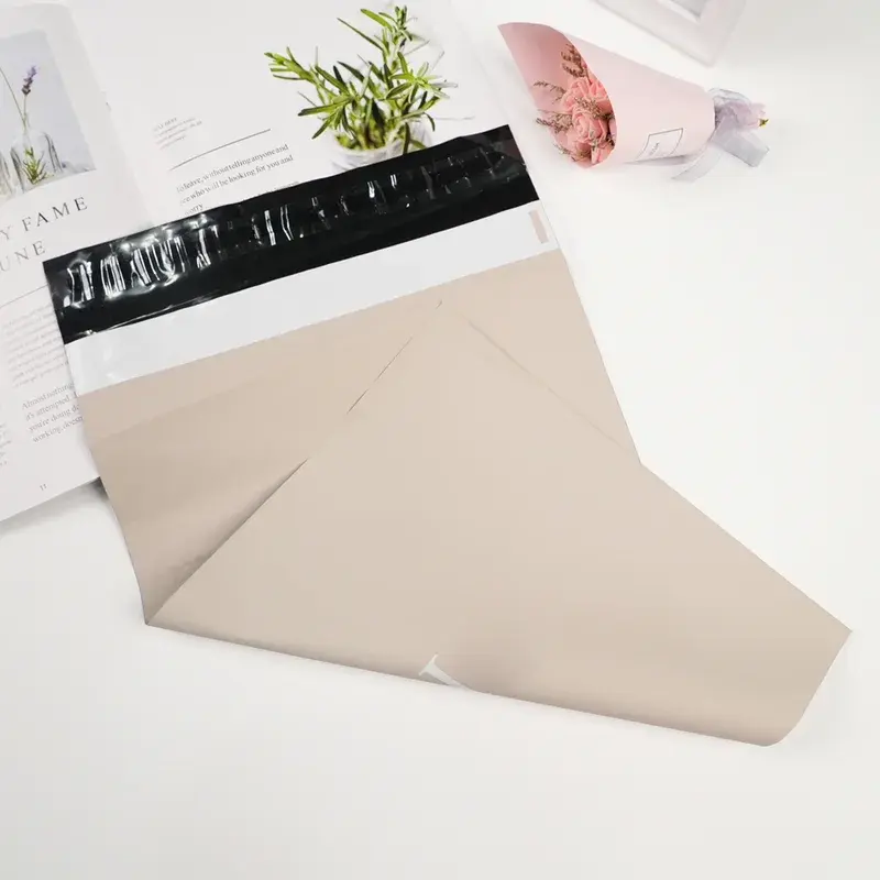 Beige mailing bag with a black adhesive strip exposed.