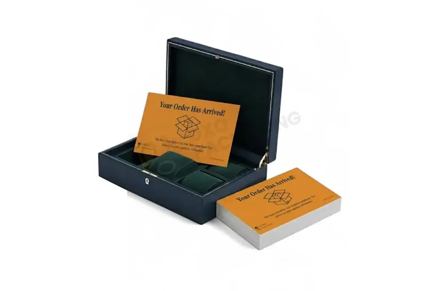 Open black box holding orange printed cards beside a card stack.