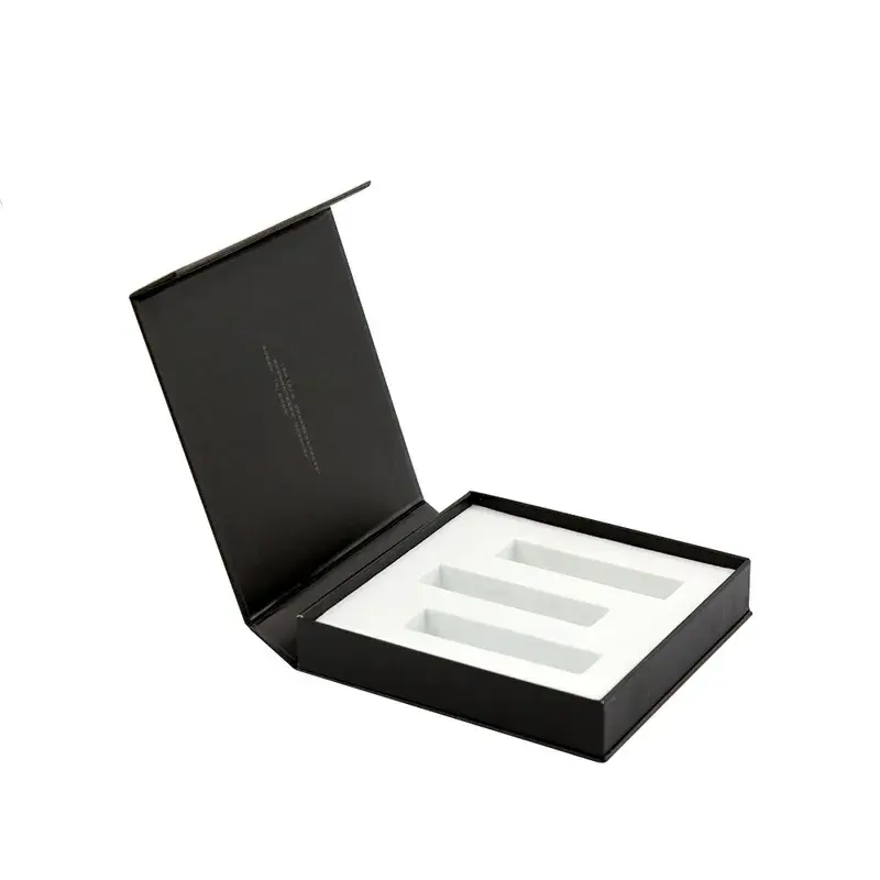 Open black box with a white insert and rectangular cutouts.