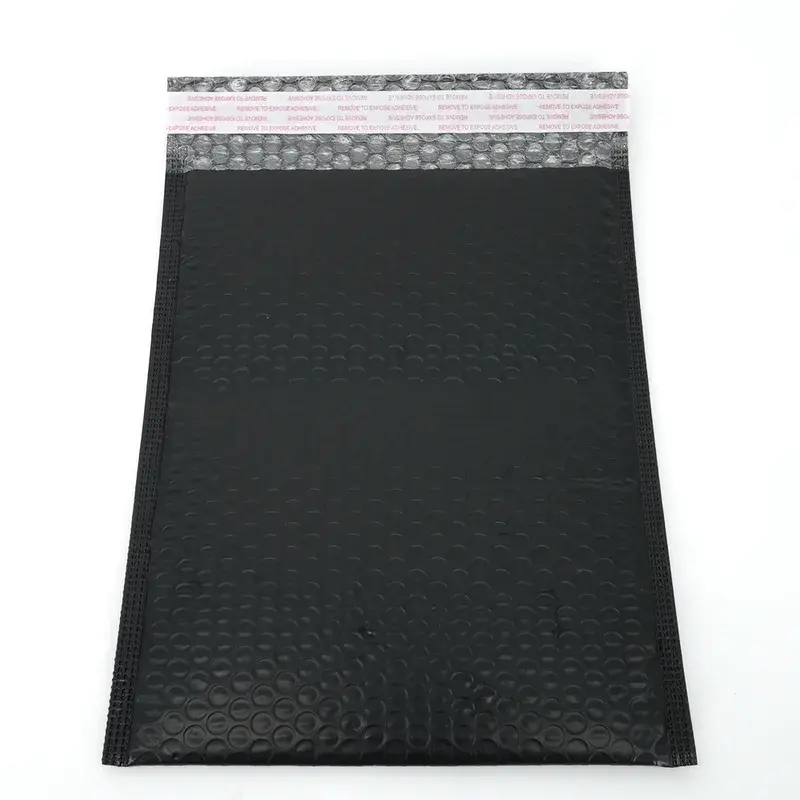 Black bubble mailer with an open adhesive sealing flap.