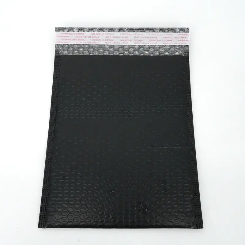 Black bubble mailer with an open adhesive sealing flap.