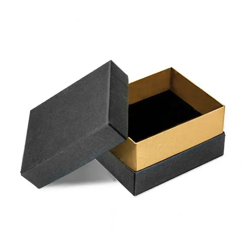 Open black presentation box with a gold-colored inner rim.