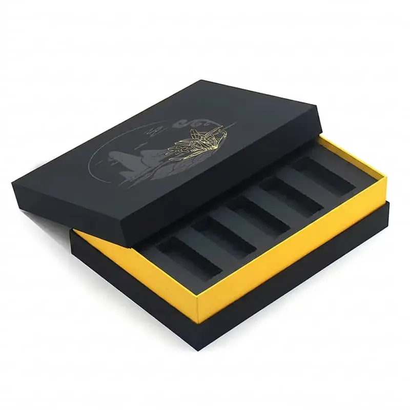 Open black presentation box with a gold-colored edge and dividers.