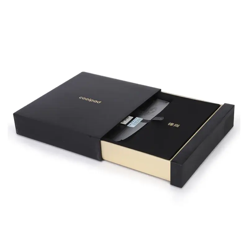 Partly open black drawer box with a gold-colored inner tray.