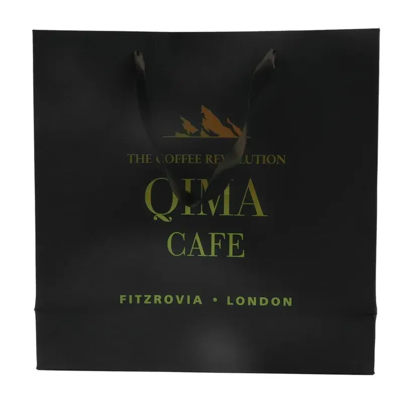 Front view of a black shopping bag with gold-colored lettering.