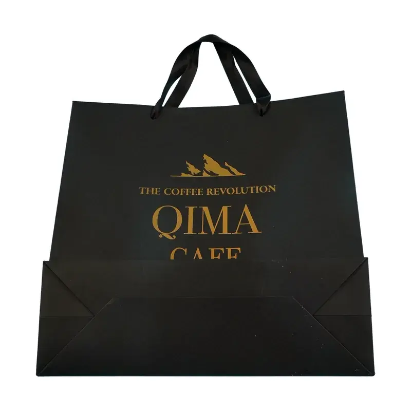 Black printed paper bag showing its folded bottom panel.