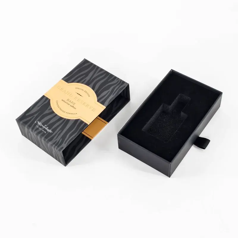 Black patterned drawer box beside a fitted black inner tray.
