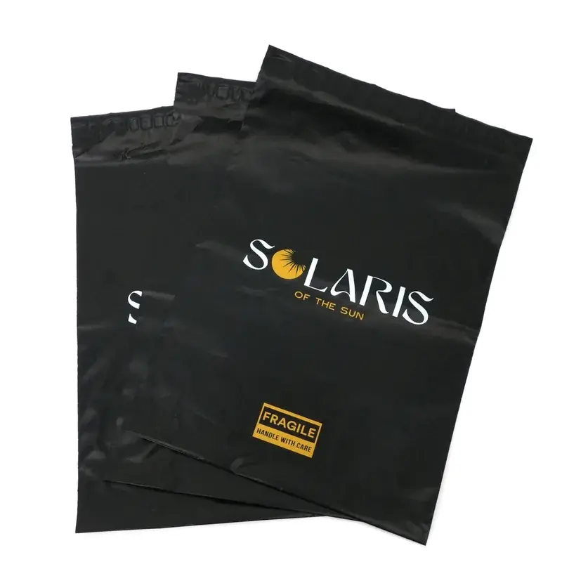 Black mailing bags with gold and white printed lettering.