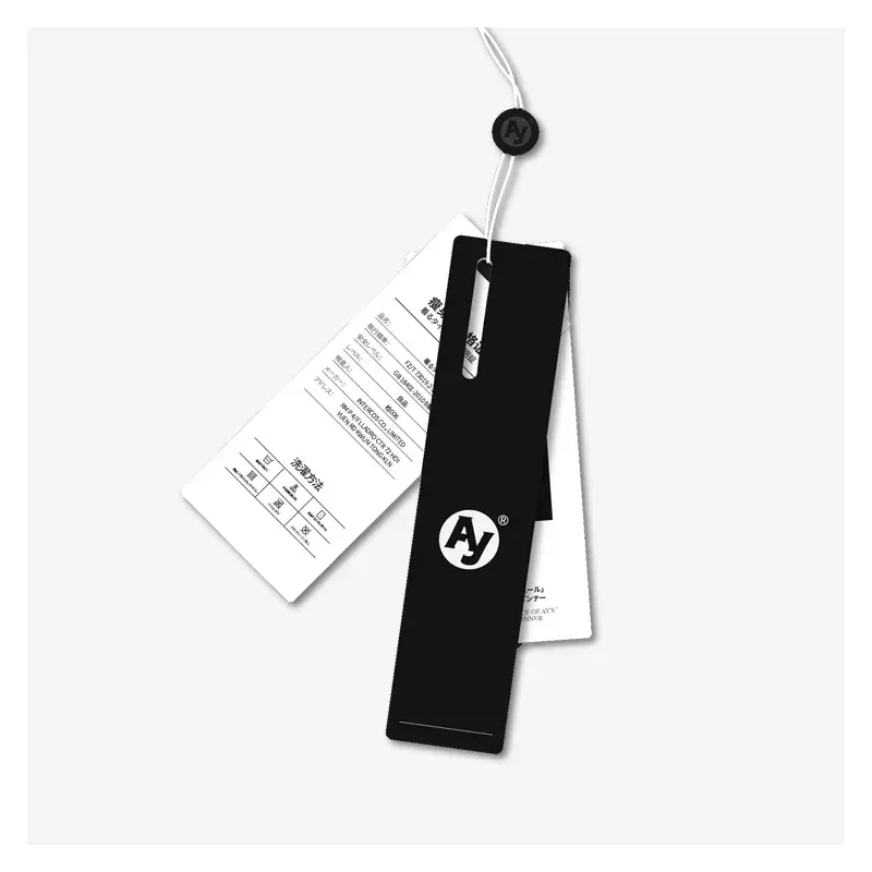 Black and white clothing tags joined by a cord and round fastener.