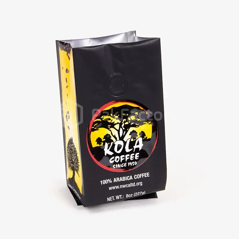 Black coffee pouch with yellow graphics and a broad flat base.