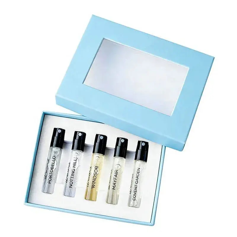 Open pale blue window box holding a row of small perfume bottles.