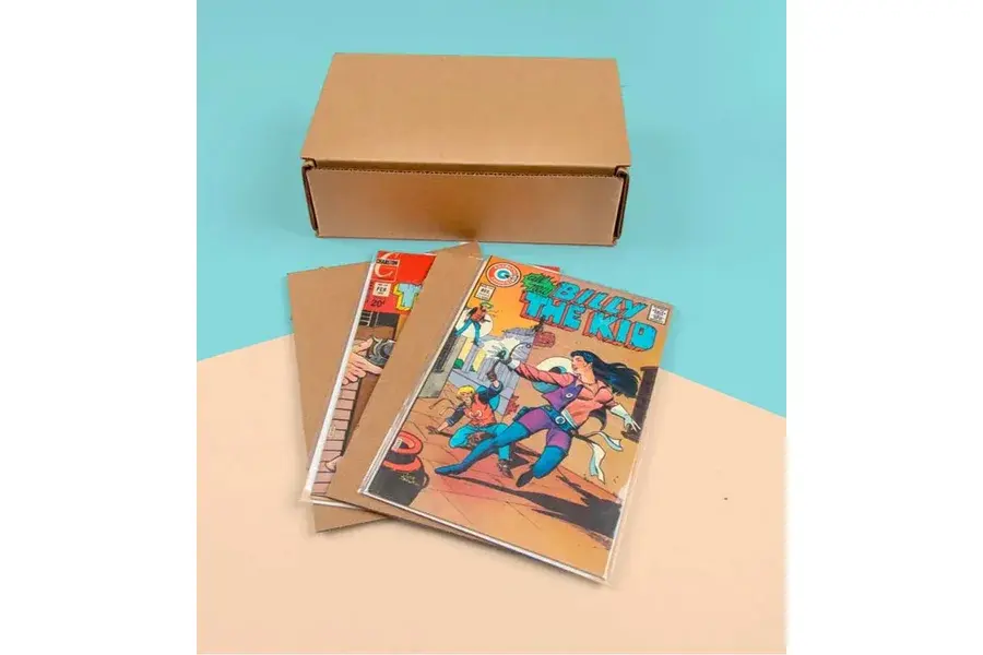 Illustrated books beside a closed kraft mailing box.