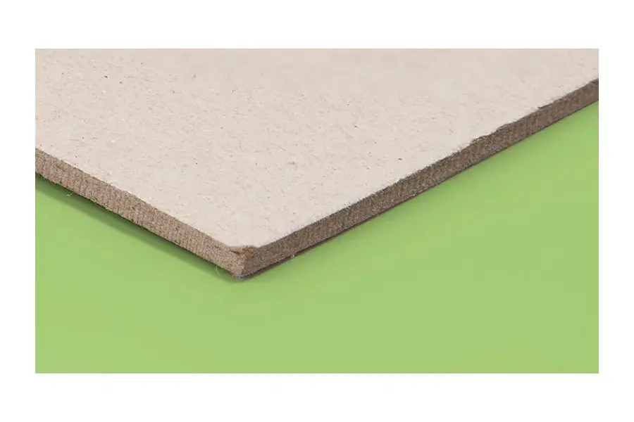Close view of a brown board edge on a green background.