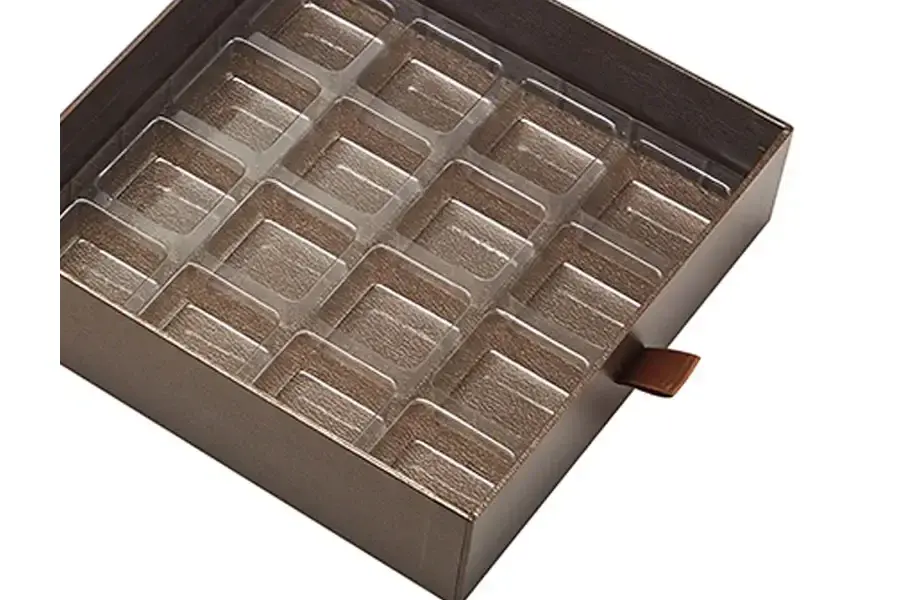 Brown rectangular tray with multiple small recessed compartments.