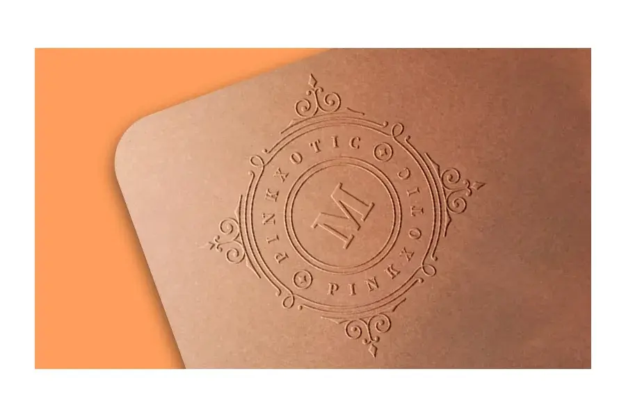 Close view of a circular design pressed into brown paper.