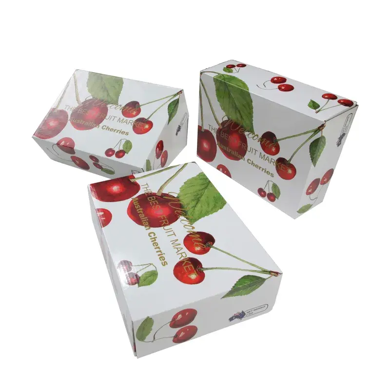 Several white cartons printed with red cherries and green leaves.