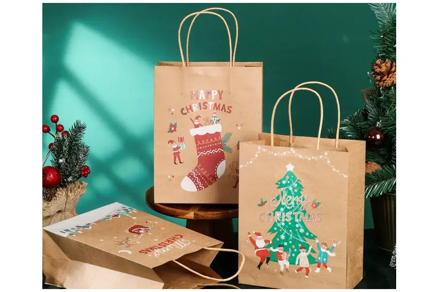 Christmas-printed kraft bags against a green festive backdrop.