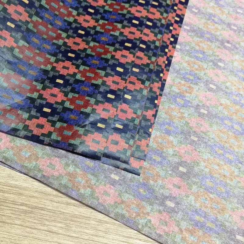 Overlapping tissue sheets with dense colorful floral patterns.