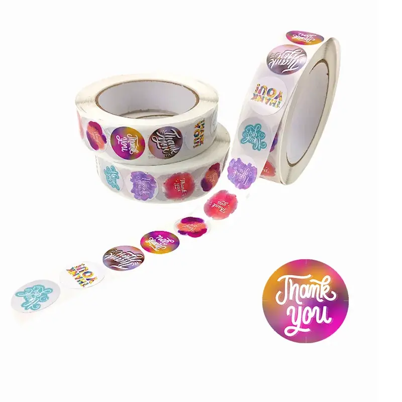 Colorful round label rolls with loose illustrated stickers.