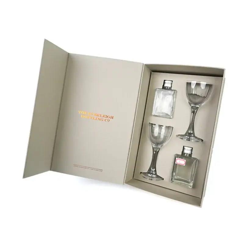 Open cream gift box holding glassware in a fitted insert.