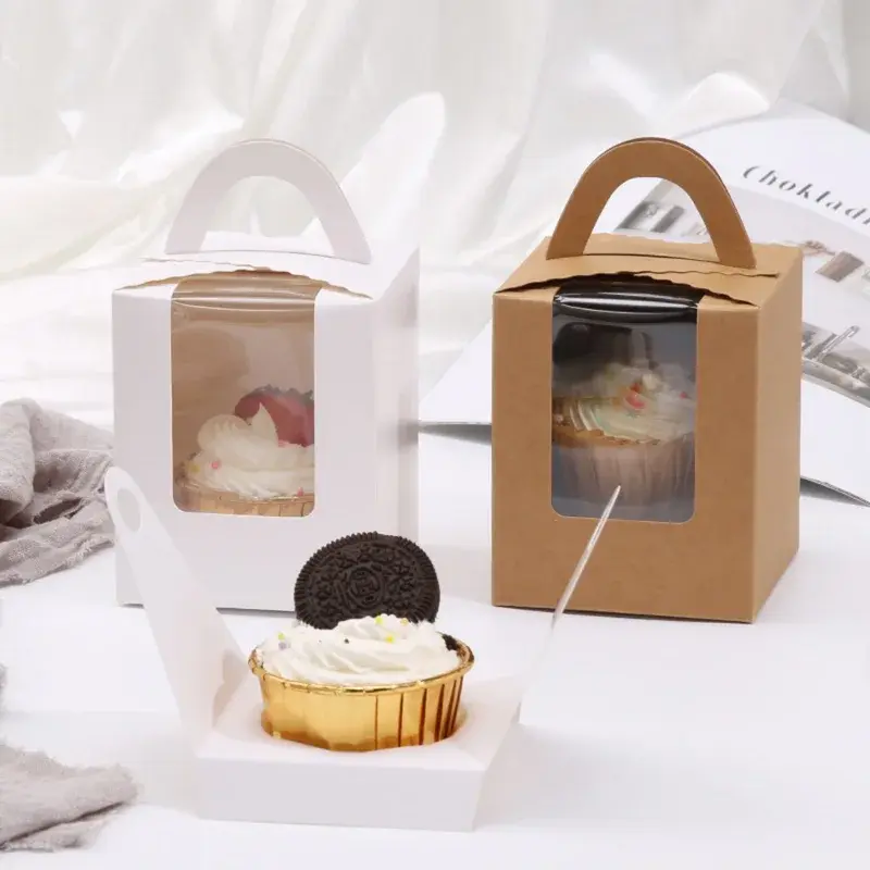 White and kraft cupcake boxes with windows and arched handles.