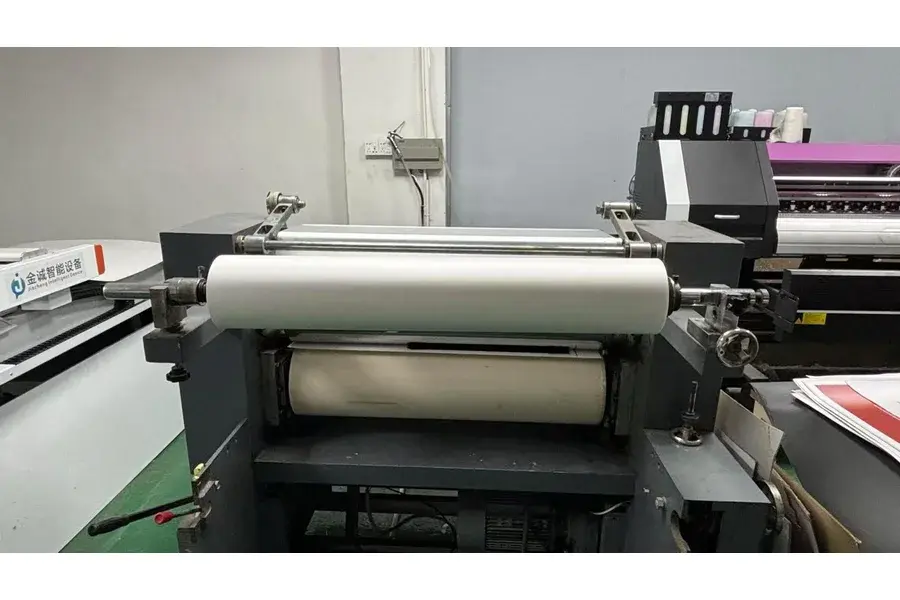 Large roller machine in a factory production area.
