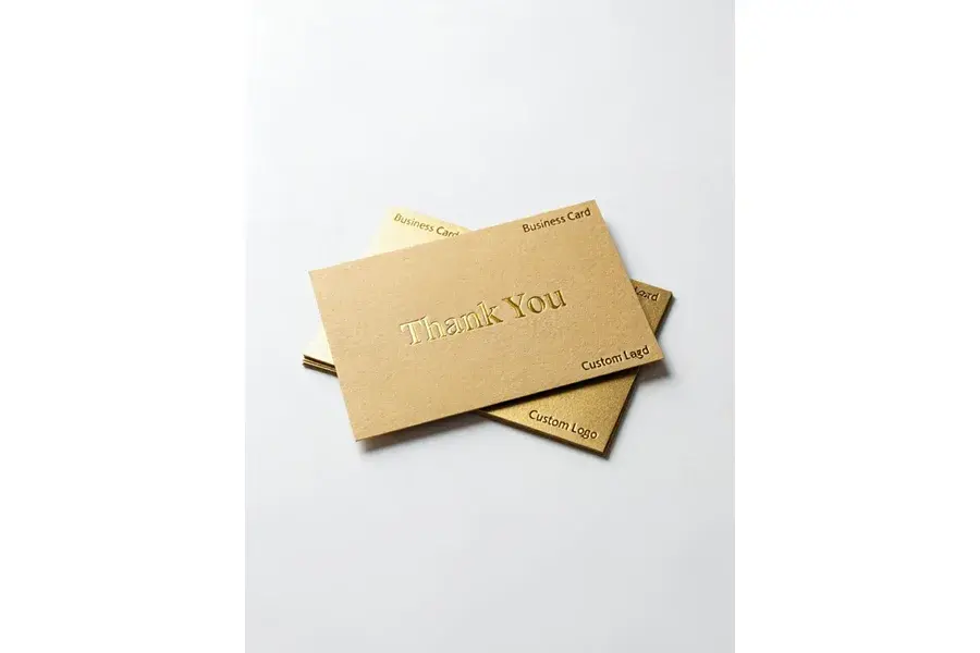 Overlapping gold-colored cards with thank-you lettering.