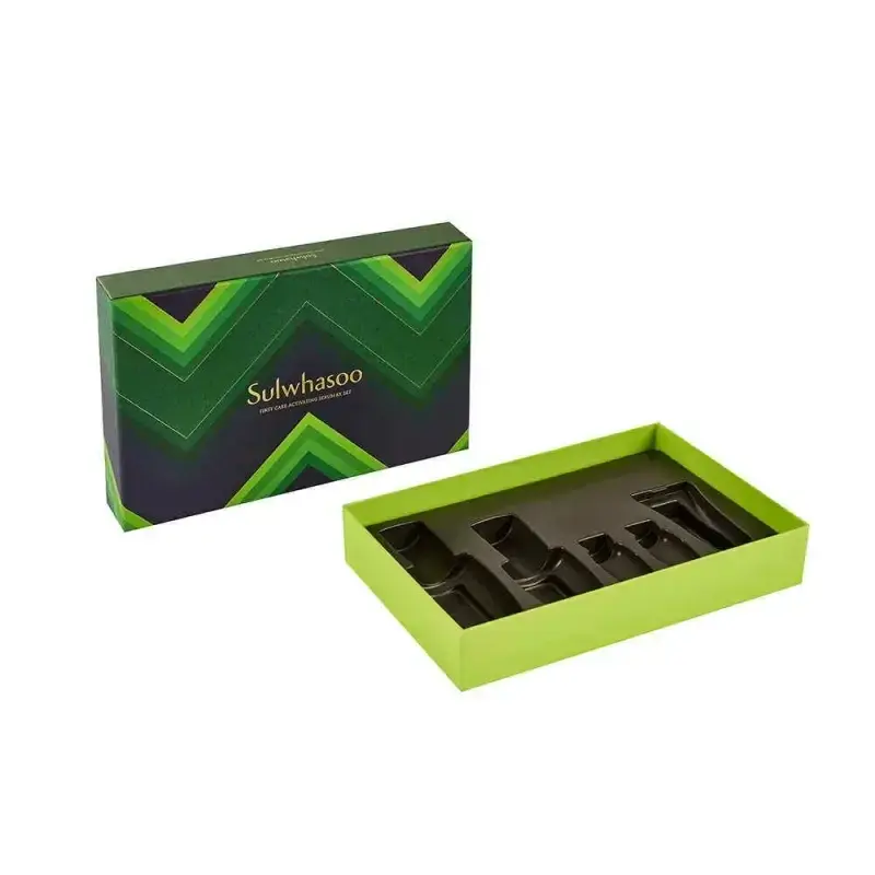 Green presentation box with a dark compartmented insert.