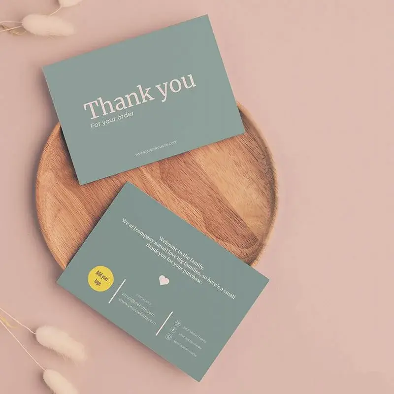 Green printed cards arranged beside a small wooden tray.