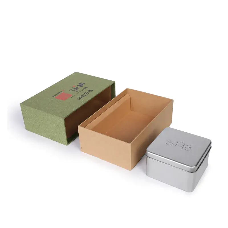 Green sleeve, brown drawer tray and small metal tin.