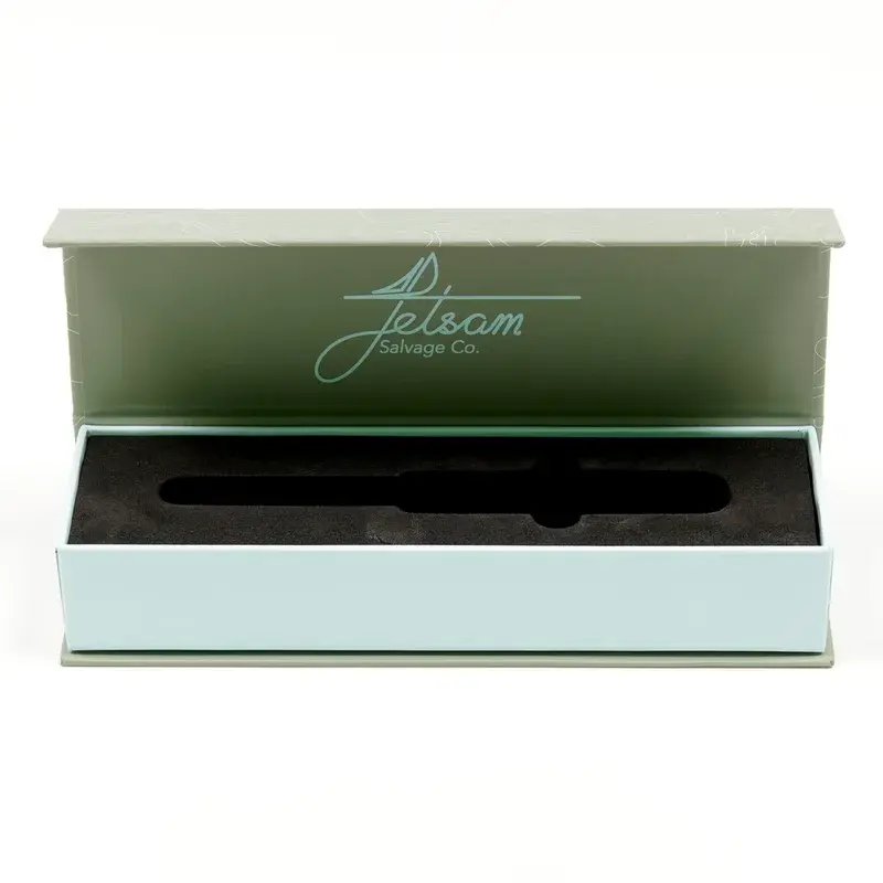 Open long green box with a black fitted insert.