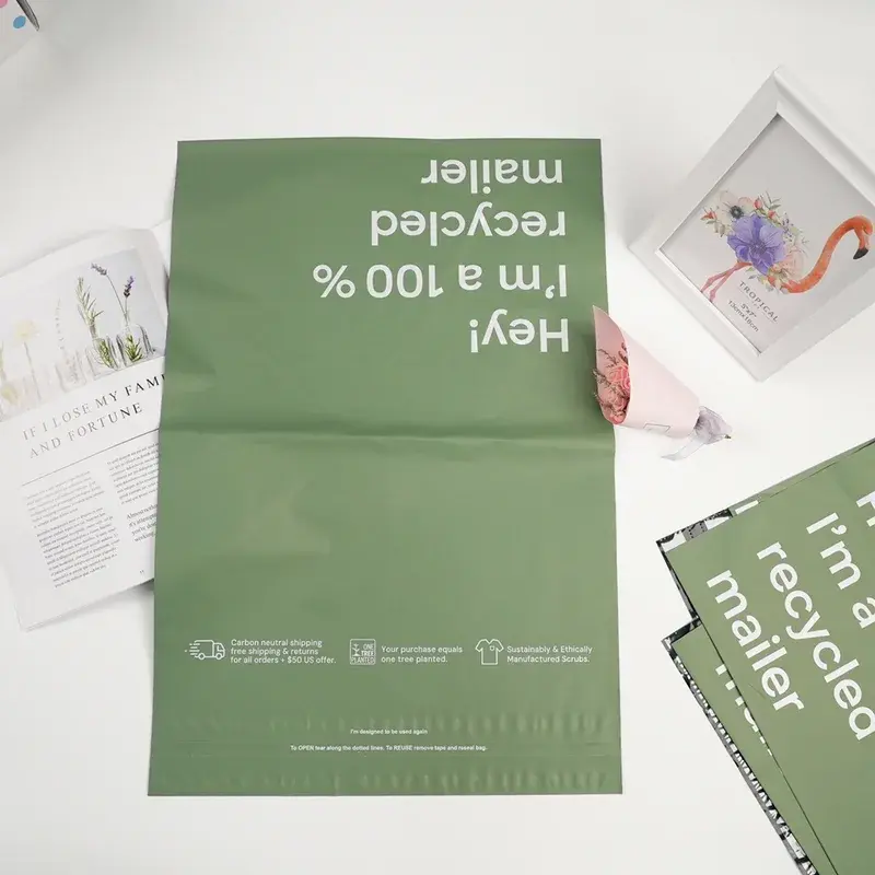 Green printed mailing bag laid open on a pale surface.