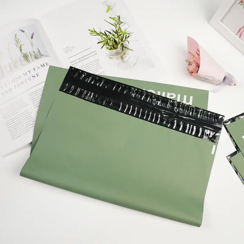 Green mailing bag with a black adhesive strip exposed.