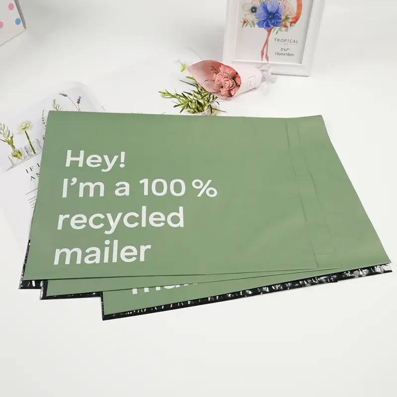 Angled view of a green printed mailing bag.