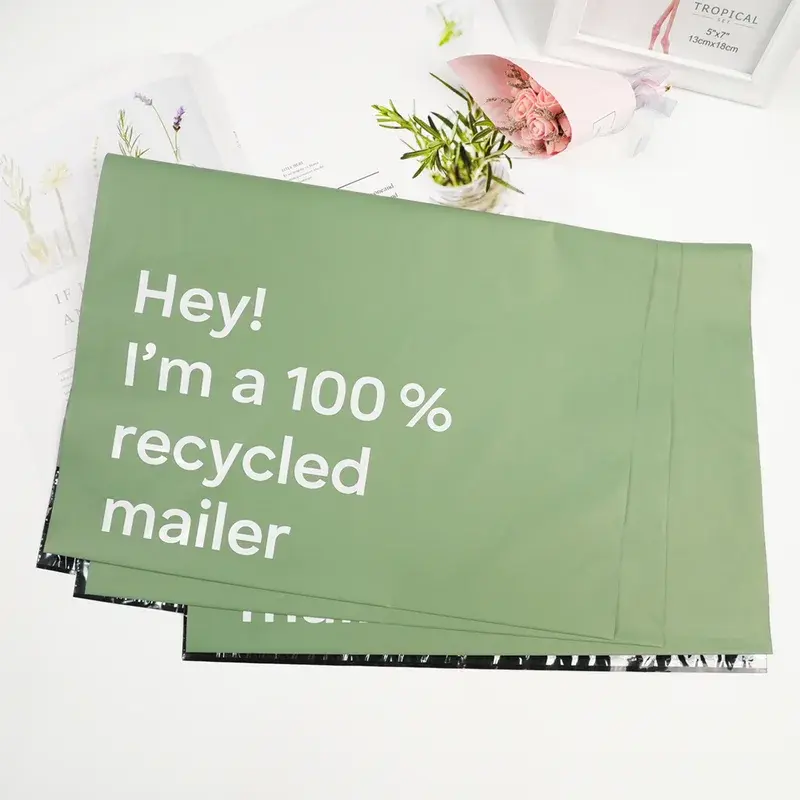 Green mailing bag with large white lettering across its front.