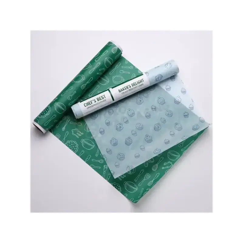 Green and white printed wrapping sheets with a small paper roll.