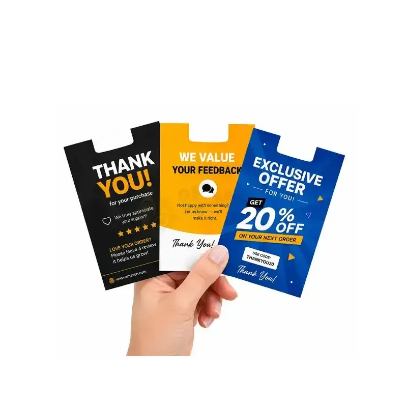 Hand holding black, yellow and blue promotional cards.
