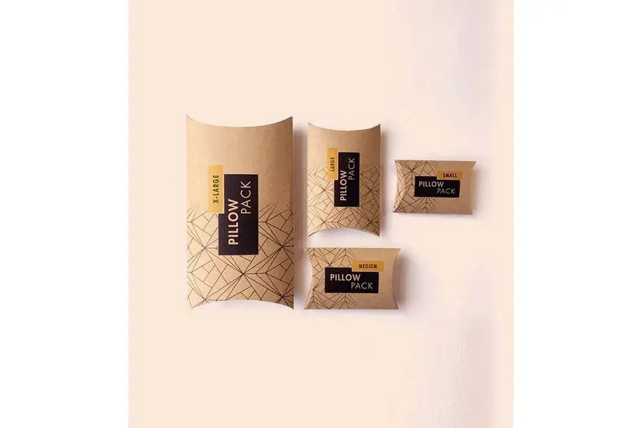 Kraft pillow boxes in several sizes with dark printed labels.