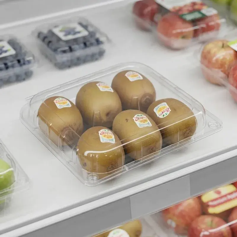 Clear clamshell holding kiwi fruit with small oval labels.