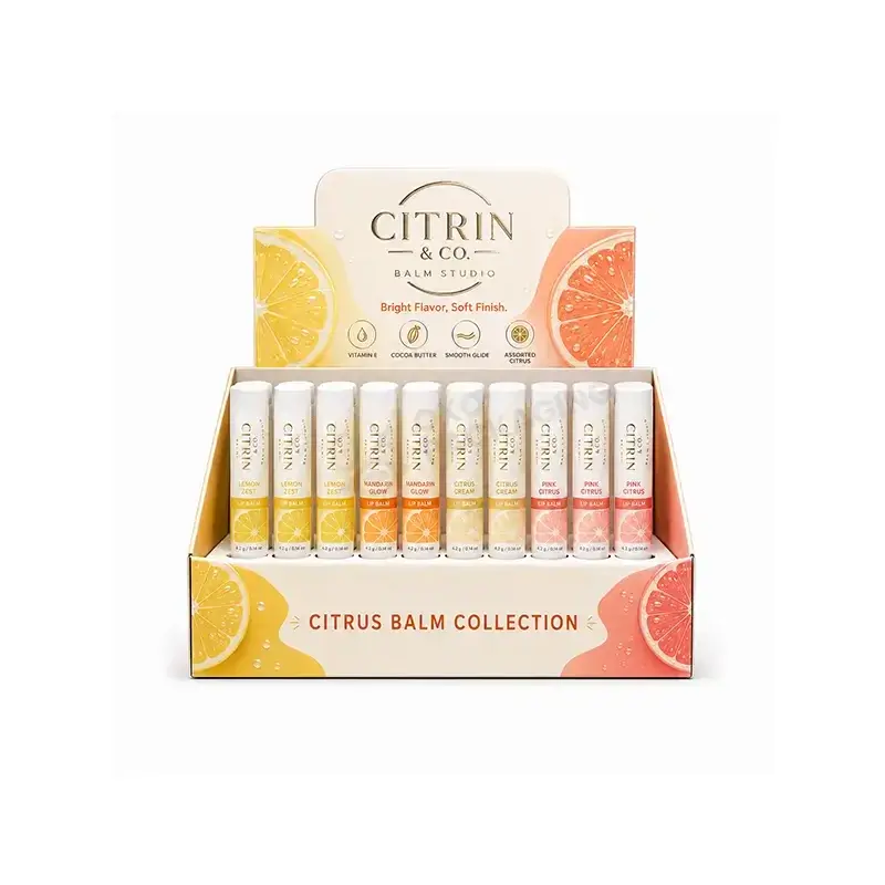 Small countertop display holding rows of labeled lip balm tubes.