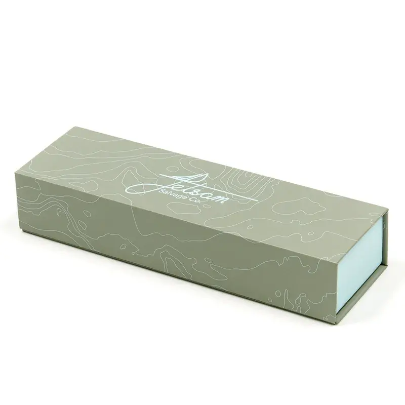 Closed long green presentation box with pale printed decoration.