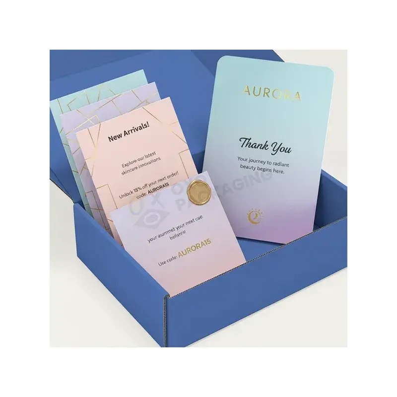Pastel printed cards standing inside a blue box.