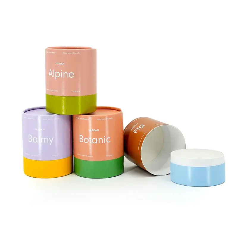 Pastel cylindrical boxes with contrasting colored bases and loose lids.
