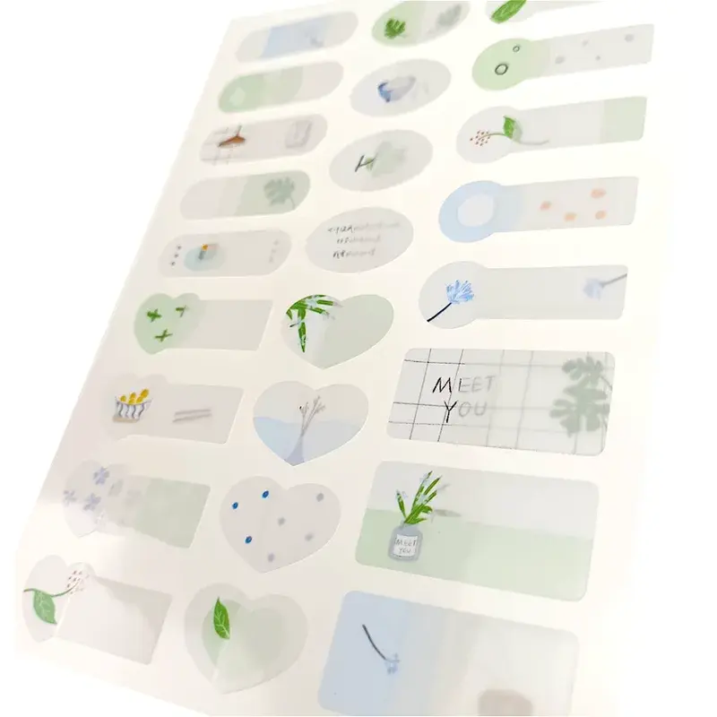 Angled view of a pastel sheet with small illustrated stickers.