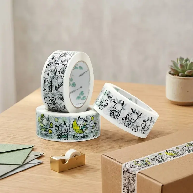 White and green patterned tape rolls on a wooden tabletop.