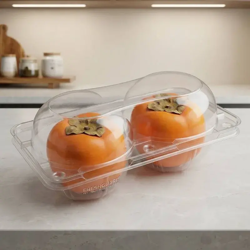 Two orange persimmons in a clear lidded container.