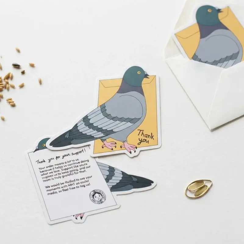 Illustrated pigeon cards arranged beside white envelopes.